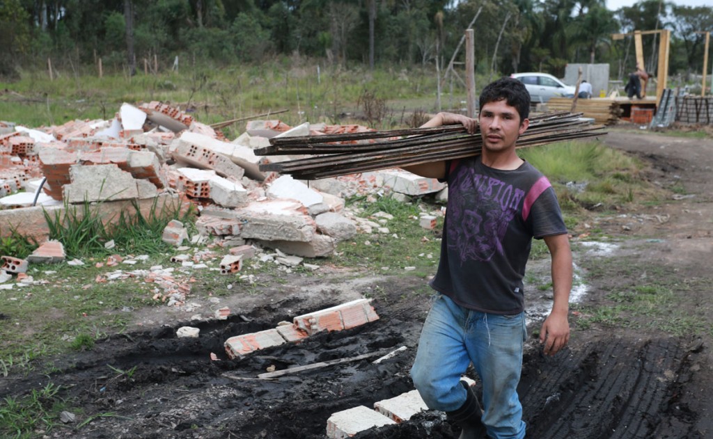 Sidnei Marino, 28 anos, era um dos moradores da Vila 29 de Outubro que estavam desmontando a casa de madeira. Foto: Felipe Rosa.