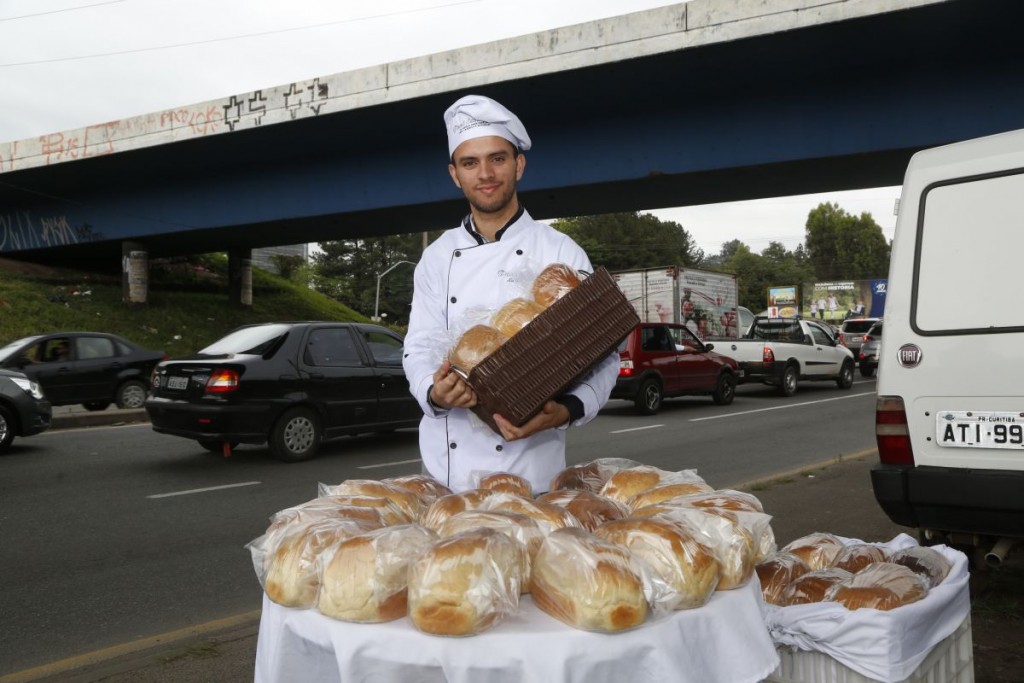 Rapaz faz pães para vender em sinaleiros de Curitiba. Foto: Átila Alberti/Tribuna do Paraná