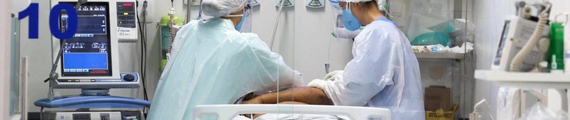 Equipe médica e paciente em UTI exclusiva covid-19