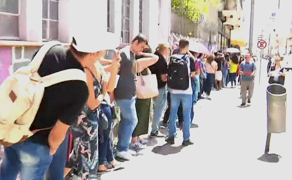 Imagem mostra pessoas em uma fila gigante no Centro de Curitiba.