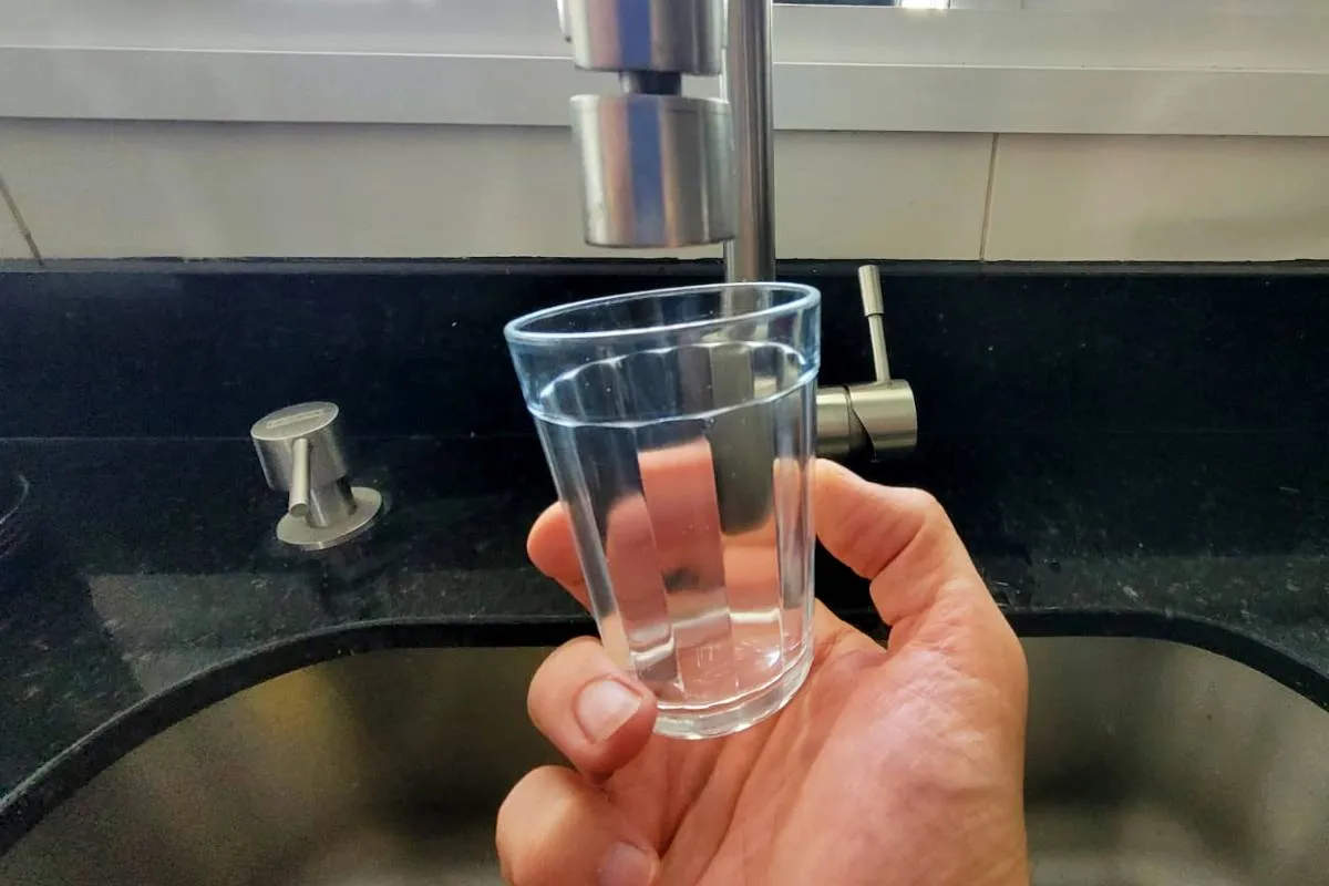 Na imagem, copo e torneira sem água.