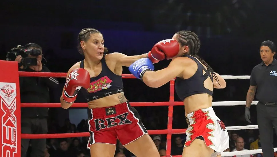 na imagem duas lutadoras trocam socos dentro de um ringue