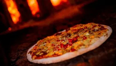 Imagem mostra uma pizza de Barreado