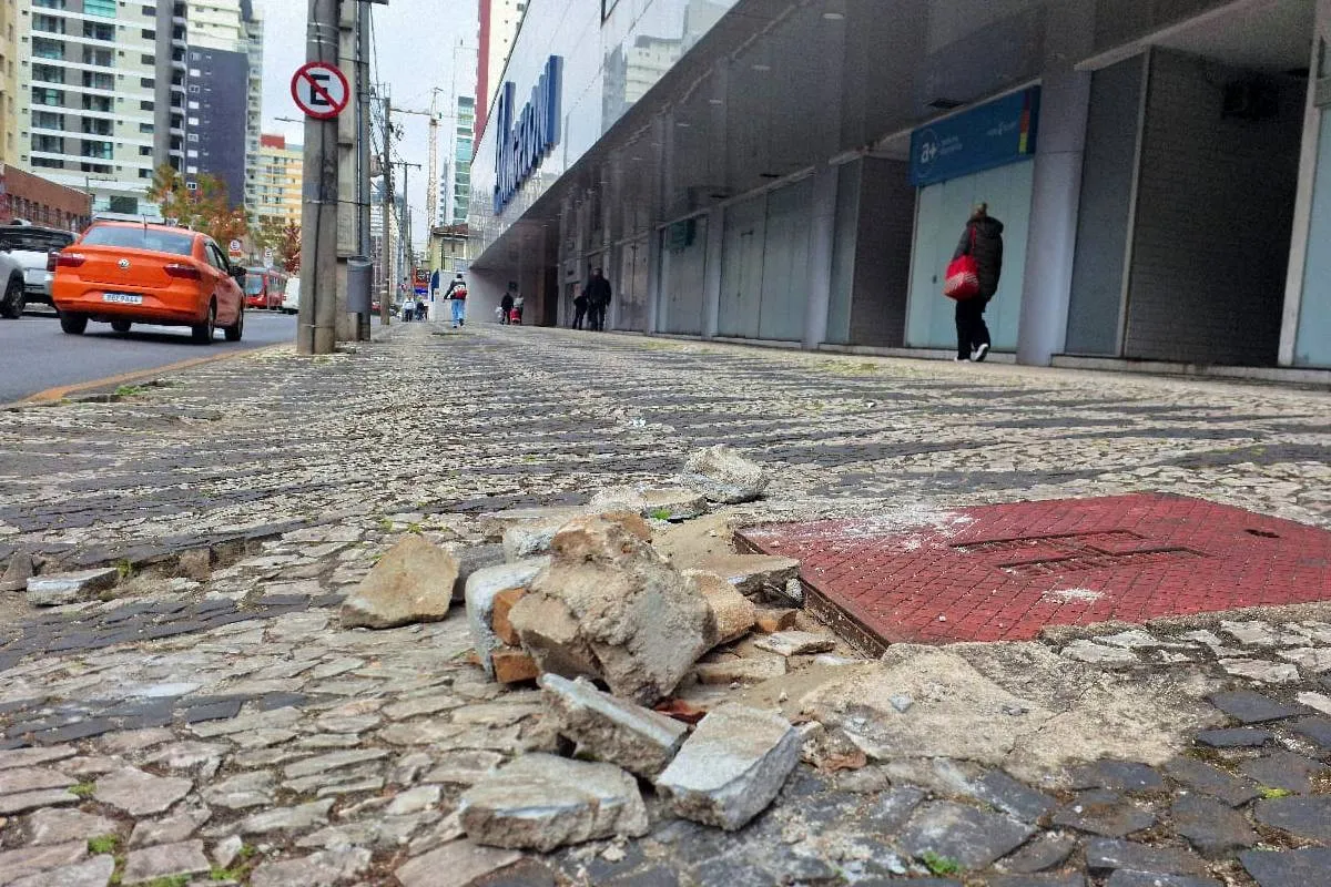 Imagem mostra uma calçada destruída em Curitiba.