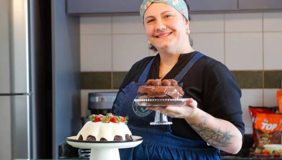 Imagem mostra uma confeiteira fazendo um belo e saboroso bolo.