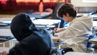 Imagem mostra estudantes realizando atividades durante aula em escola estadual do Paraná