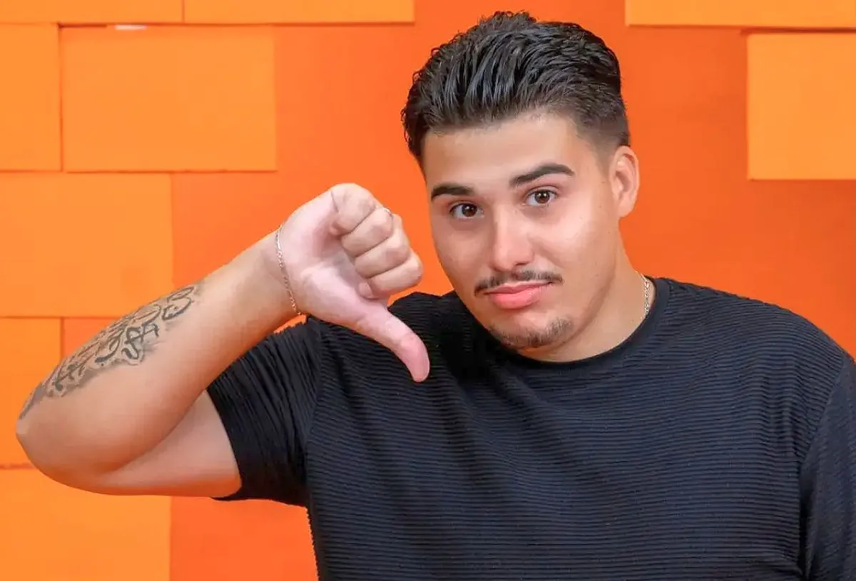 imagem mostra o participante Pedro, do BBB 26, fazendo gesto de desaprovação, com o polegar para baixo