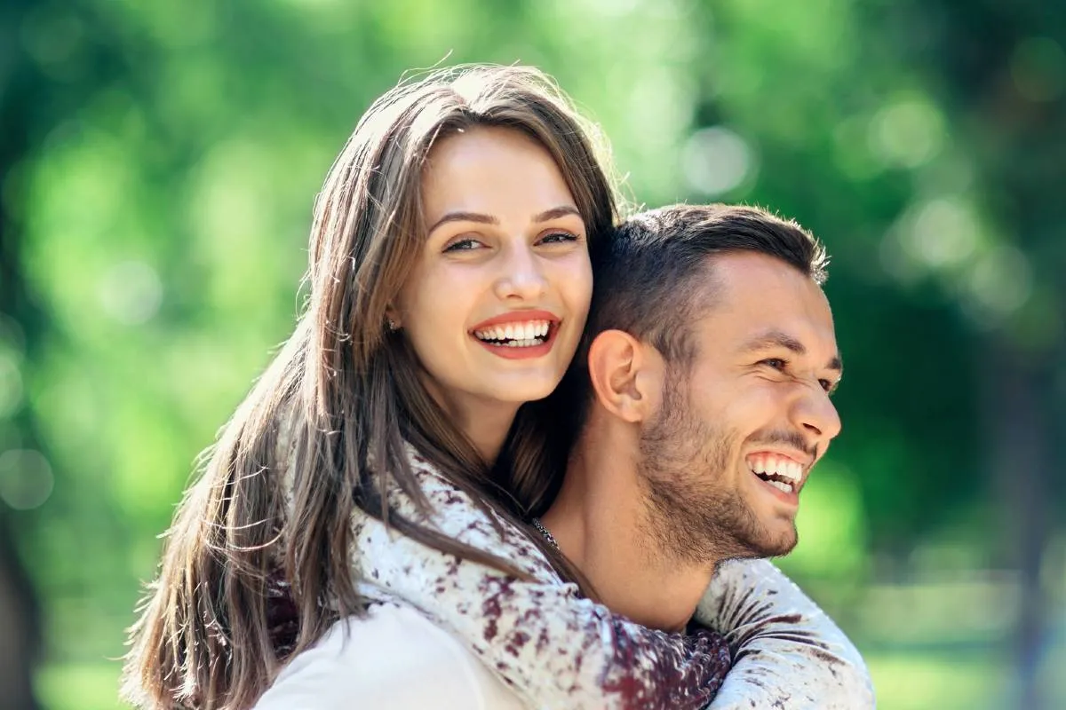 Imagem mostra um casal se abraçando.