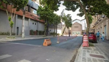 Imagem mostra um trecho de uma rua de Curitiba com bloqueios e fitas indicando nova direção.