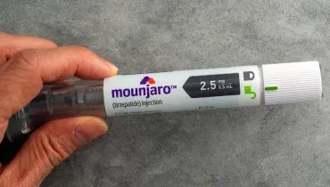 Imagem mostra uma pessoa segurando uma caneta emagrecedora da Mounjaro.