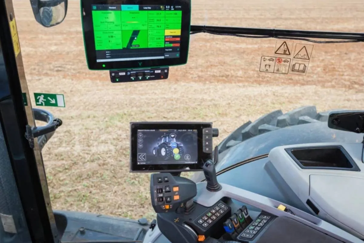 Imagem mostra um trator no campo atuando com a ajuda de IA, com telas e tecnologia embarcada.