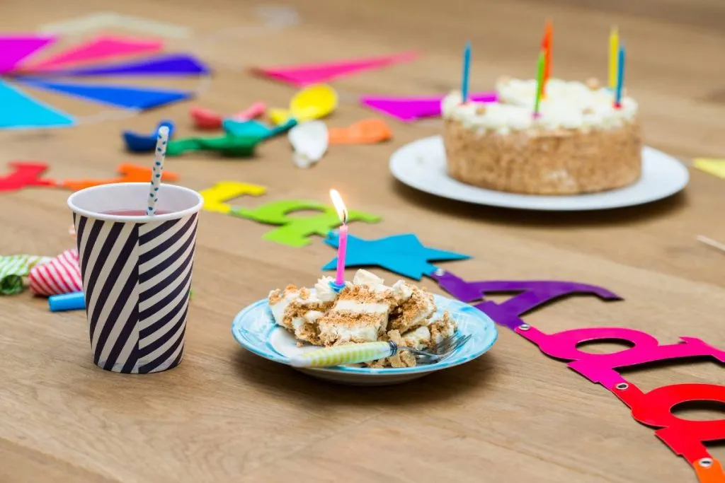 Imagem mostra um bolo de aniversário servido em um pratinho.